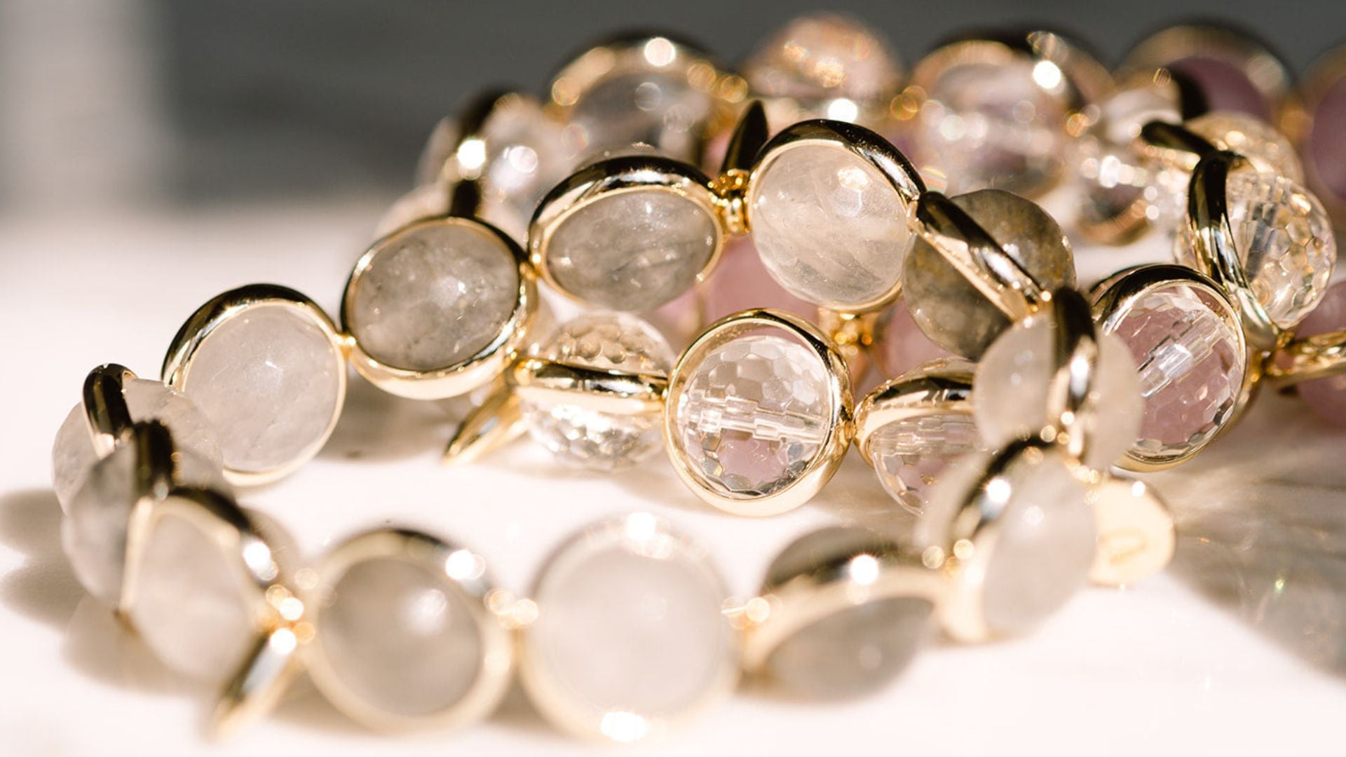 A banner featuring neutral gemstones for Brett Lauren's neutral gemstone jewelry collection, highlighting soft beige, cream, and natural stone tones in elegant bracelets.